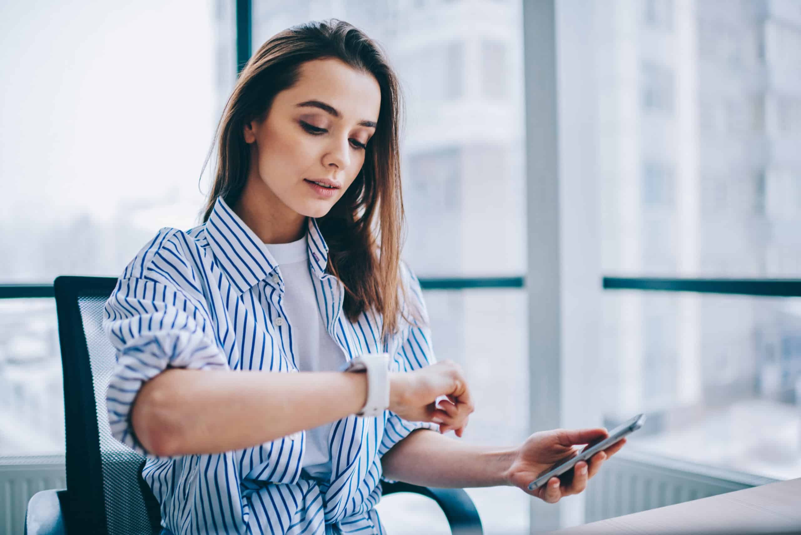 Young,Attractive,Female,Checking,Time,Of,Wrist,Watches,While,Sitting