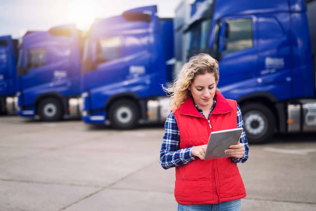 Truck,Driver,Holding,Tablet,And,Checking,Route,For,New,Destination.